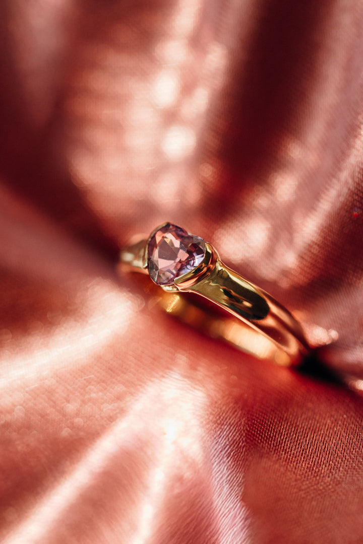 Goldring Mon Cœur mit herzförmigem rosafarbenem Spinell auf glänzendem Stoff